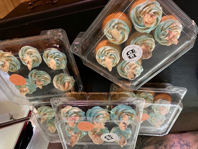Pastel blue and peach frosted cupcakes