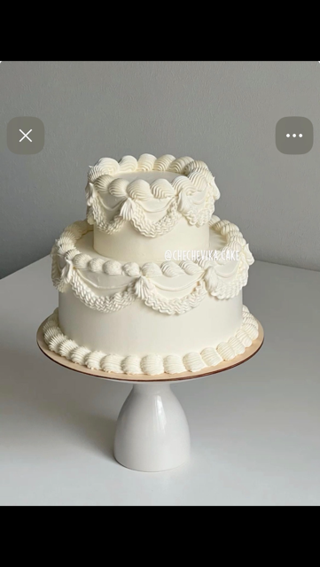 Vintage-style ivory cake with intricate piped swags